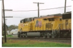 UP 7827 goes under the 10th St. bridge as she rolls south with a manifest train.